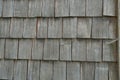 A wooden shingle in neat rows on a roof close up. A detail of a roof of a traditional Swiss countryside. Royalty Free Stock Photo