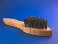 Wooden shoe brush on a blue background Royalty Free Stock Photo