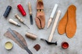 Wooden shoe with shoe tools on grey stone desk background top view