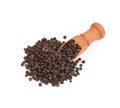 Wooden shovel with black peppercorn scattered from it