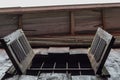 Wooden shutter of window. Grungy village house. Old countryside house detail. Rustic architecture.