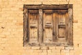 Wooden shuttered window in a yellow brick wall Royalty Free Stock Photo