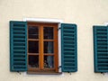 Wooden shutters on closed windows on the wall of an old house Royalty Free Stock Photo