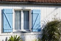 Wooden shutters open Blue window with white wooden plank facade wall Royalty Free Stock Photo