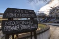 Wooden sign with directions to the honey and firewater store