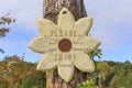 Wooden sign in flower form with inscription