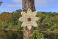 Wooden sign in flower form with inscription