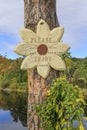 Wooden sign in flower form with inscription