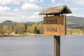 tourist signpost by the water, wooden sign with inscription Olsina Pond, Czech republic