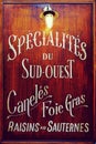 Wooden sign with lantern with french food written