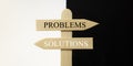 Wooden sign with the words problems and solutions