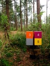 Wooden sign post mile marker on a hiking jogging trail in a forest Royalty Free Stock Photo