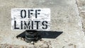 Wooden sign saying Off Limits standing on cement Royalty Free Stock Photo