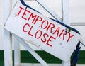 Wooden sign Temporary Close close up photo. Stencil typeface on rustic wood. Red and white nautical sign