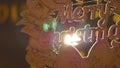 Wooden sign with text Merry christmas on the background of Christmas lights