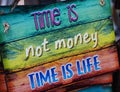Wooden sign time is not money time is life