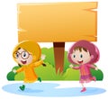 Wooden sign and two girls in raincoat