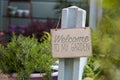 Wooden sign welcoming to the garden Royalty Free Stock Photo