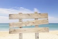 Wooden signboard on blue sky and on tropical beach for summer ba Royalty Free Stock Photo