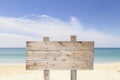 Wooden signboard on blue sky and on tropical beach for summer ba Royalty Free Stock Photo