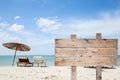 wooden signboard on blue sky , tropical beach for summer background . Royalty Free Stock Photo