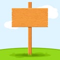 Wooden signboard in grass isolated on grass sky background. Signs board and symbols to communicate a message on street