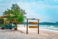 wooden signboard on tropical beach. A sign board for the name of the hotel or the beach on a background of beautiful nature on Royalty Free Stock Photo