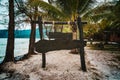 wooden signboard on tropical beach. A sign board for the name of the hotel or the beach on a background of beautiful nature on Royalty Free Stock Photo