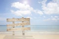 Wooden signboard on tropical beach for summer background. Royalty Free Stock Photo