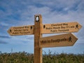 A wooden signpost on a coastal section of the Cleveland Way national trail between Robin Hood`s Bay and Whitby, Yorkshire, UK