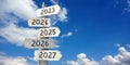 2023, 2024, 2025, 2026, 2027 - wooden signpost with five arrows