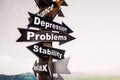 Wooden signpost with four arrows - depression, problems, stability, relax. The concept of choice Royalty Free Stock Photo