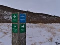 Wooden signpost in VatnajÃÂ¶kull National Park in winter season showing the direction to Svartifoss waterfall with snowy mountains. Royalty Free Stock Photo