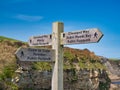 A wooden signpost near Robin Hood`s Bay marks the junction of the Cleveland Way National Trail and the England Coast to Coast pat Royalty Free Stock Photo