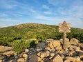 Wooden signpost perched atop a pile of rocks. Dorr Ridge, Acadia National Park, Maine, USA. Royalty Free Stock Photo