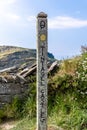 A wooden signpost showing the way to Tintagel Castle