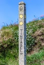 A wooden signpost showing the way to Tintagel Castle