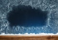 Wooden sill and frozen window. Christmas background.