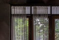 Wooden simple glass of Windows and White lace curtains in traditional thai house Royalty Free Stock Photo