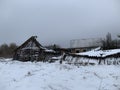 Wooden skewed house in the field. The wooden building fell into disrepair. Old, ruined house from a log house Royalty Free Stock Photo