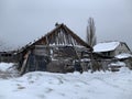 Wooden skewed house in the field. The wooden building fell into disrepair. Old, ruined house from a log house Royalty Free Stock Photo