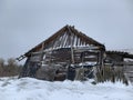 Wooden skewed house in the field. The wooden building fell into disrepair. Old, ruined house from a log house Royalty Free Stock Photo