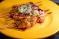 Wooden skewers with pieces of chicken fillet in teriyaki sauce from the grill served at yakitori restaurant in Milan, Italy Royalty Free Stock Photo