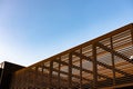 Wooden slat shading structure with roof against sky Royalty Free Stock Photo