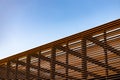 Wooden slat shading structure with roof against sky Royalty Free Stock Photo