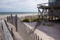 A wooden slated sand fence is partly buried in an ocean beach dune. Royalty Free Stock Photo