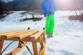 Wooden sledge closeup pulled by a boy uphill the snow mountain Royalty Free Stock Photo