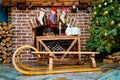 wooden sleds and socks for a gift from Santa Claus hang on the fireplace.