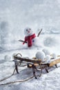 Wooden sleigh and snowballs with snowman