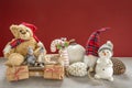 Wooden sleigh with a teddy bear, snowman, pixy, candy cane, Christmas baubles, children, pine cones and gifts